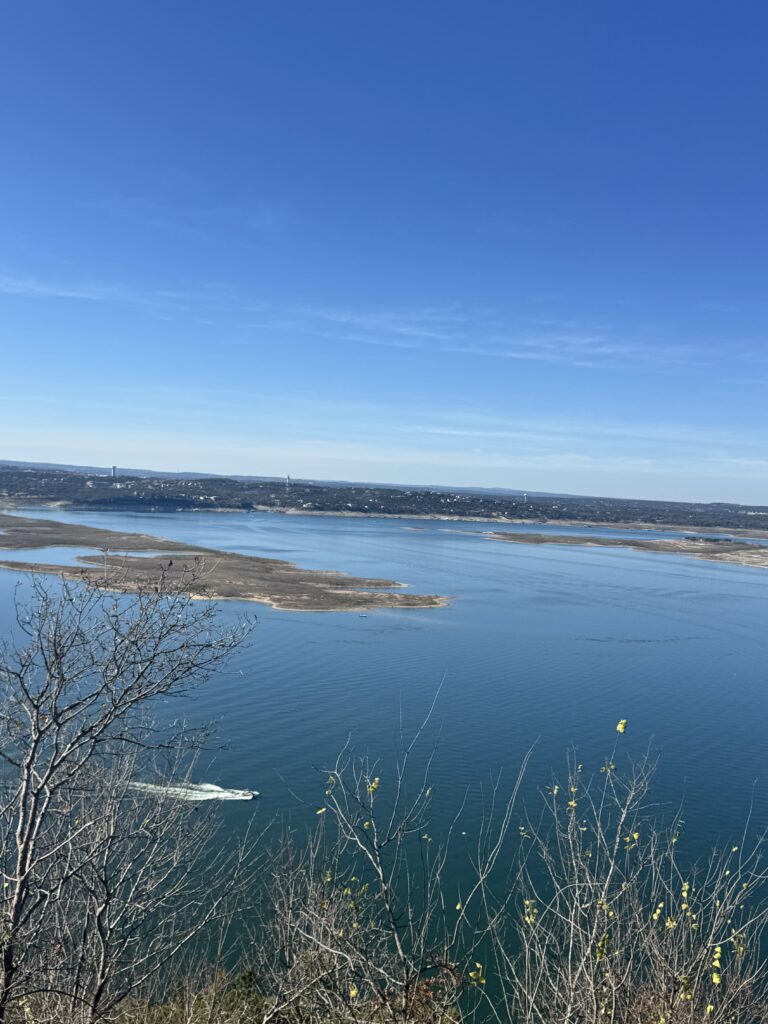 Lake Travis Aerial view with a white speedboat driving by