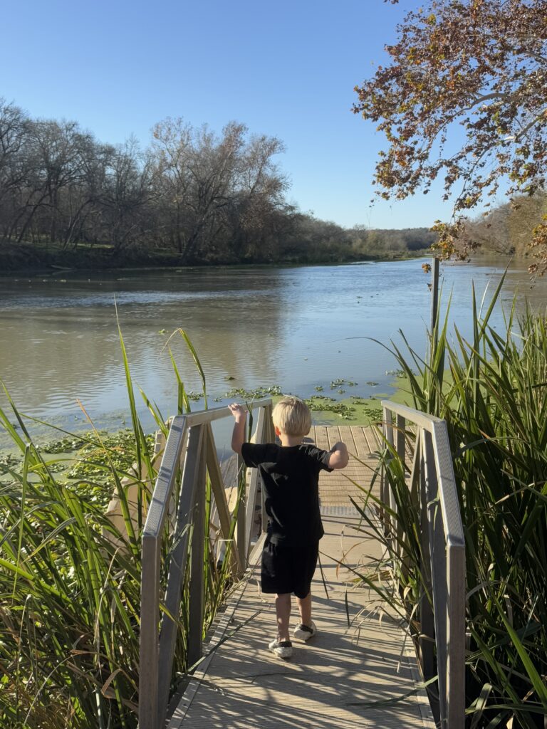 Little Boy walking onto a dock that leads up to the Colorado River