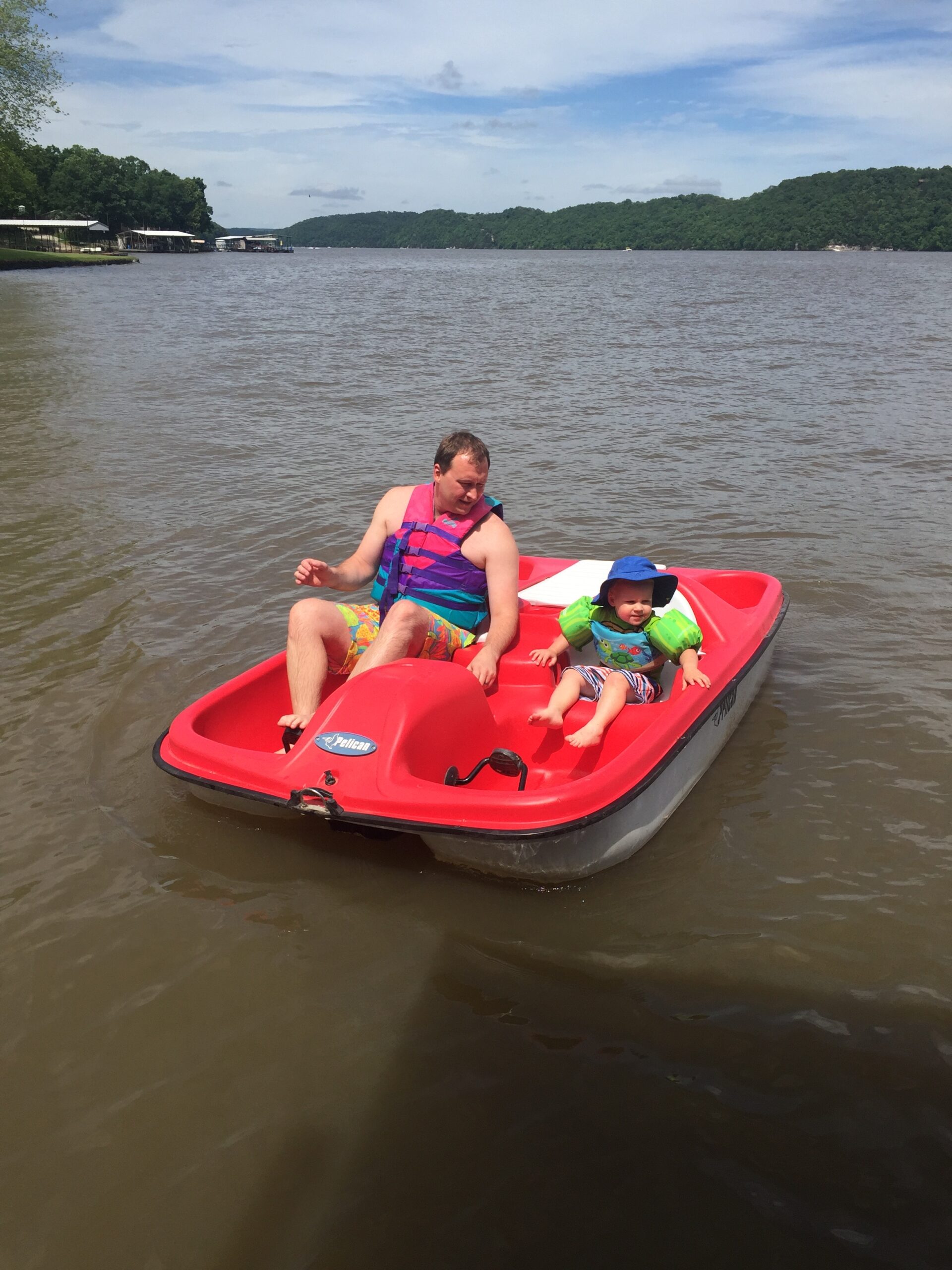 Dad and Son on a Paddle Boat at the Lake