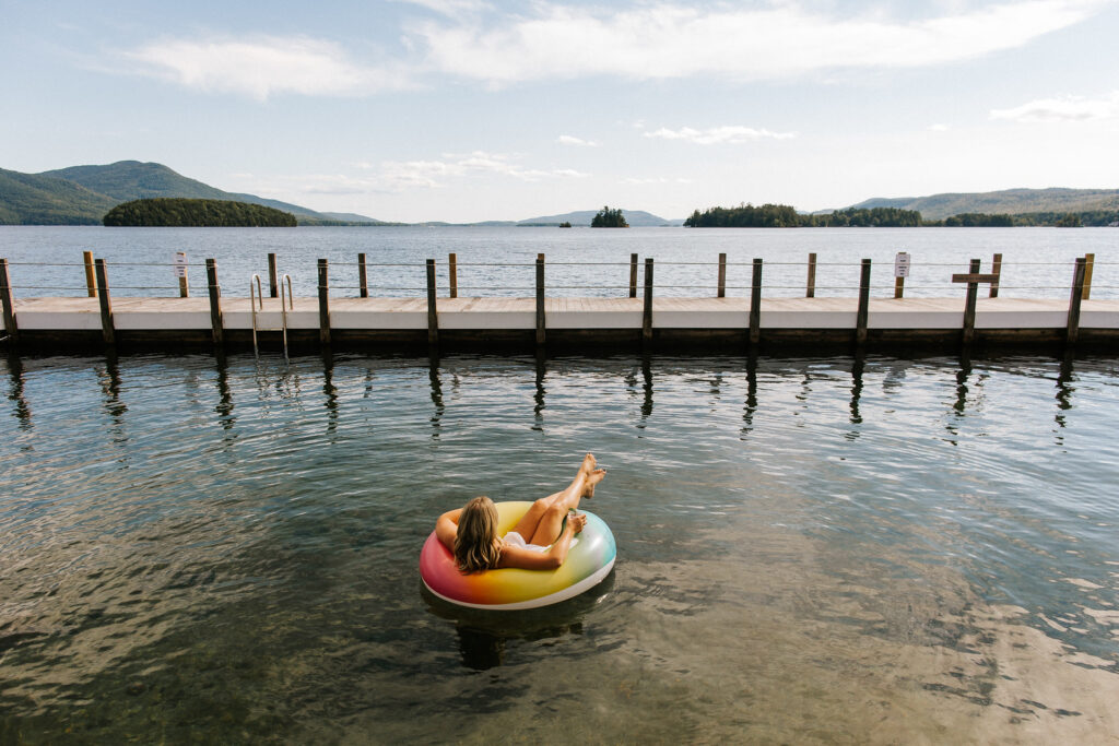 Woman floating in a tube at Lake George outside of the Sagamore Resort