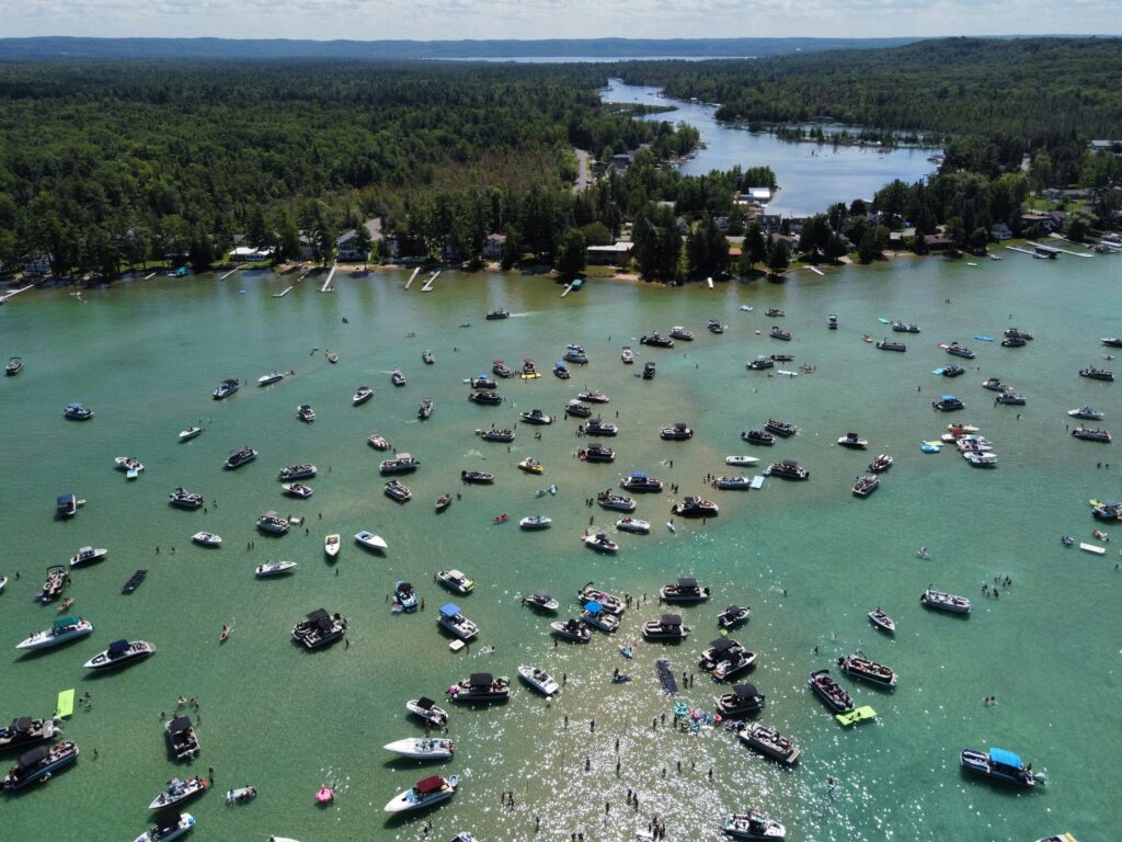 Torch Lake Sandbar with lots of boats tied up and anchored