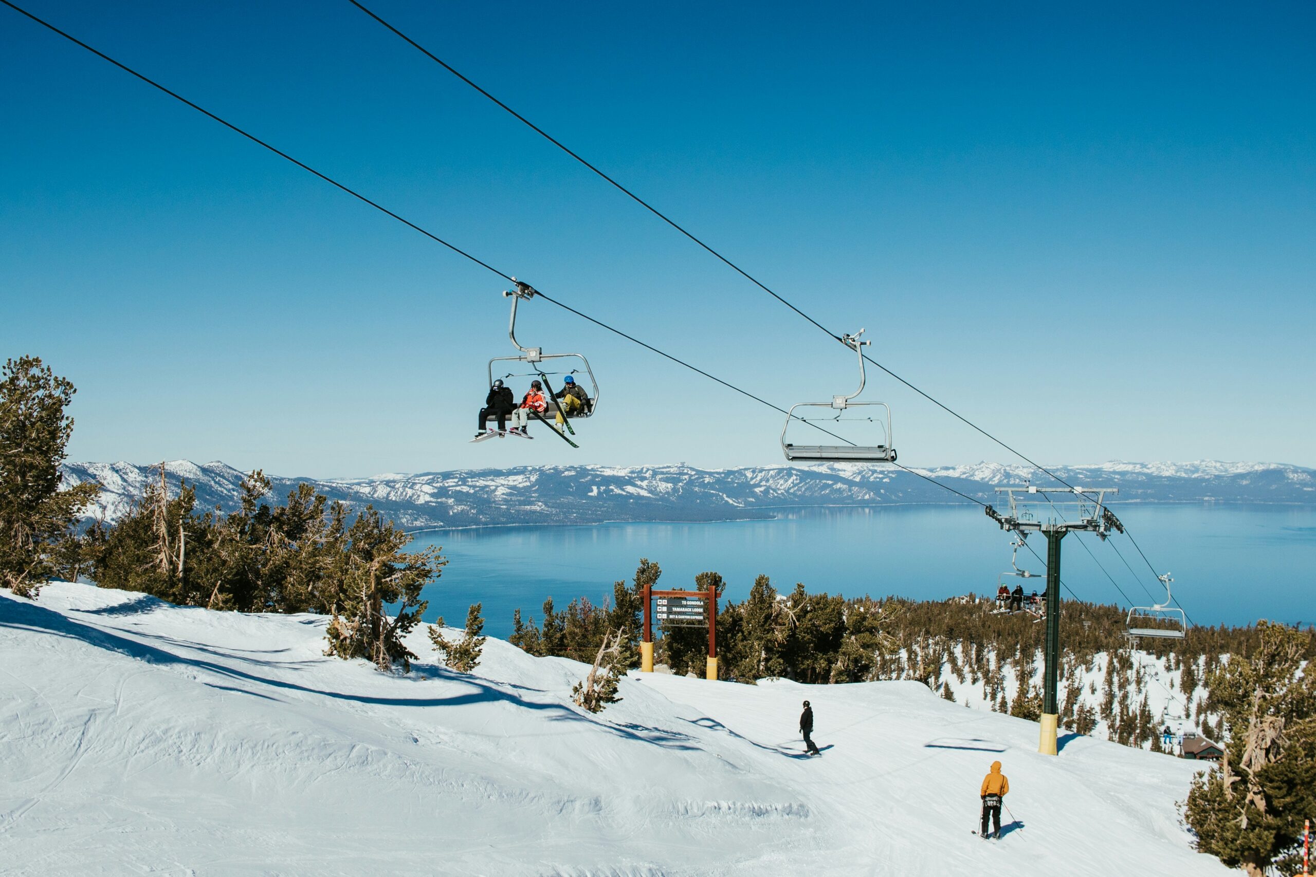 Lake Tahoe Heavenly Ski Resort, skiers on the ski lift with Lake in the background