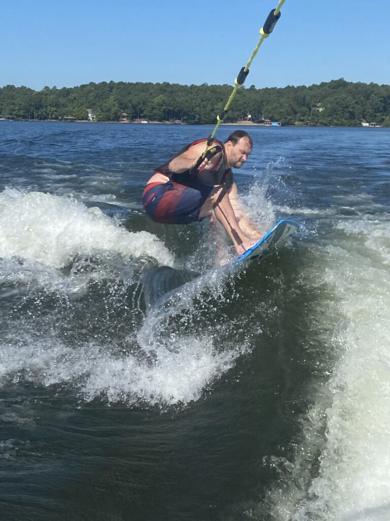 Wake surfer hitting a wake high