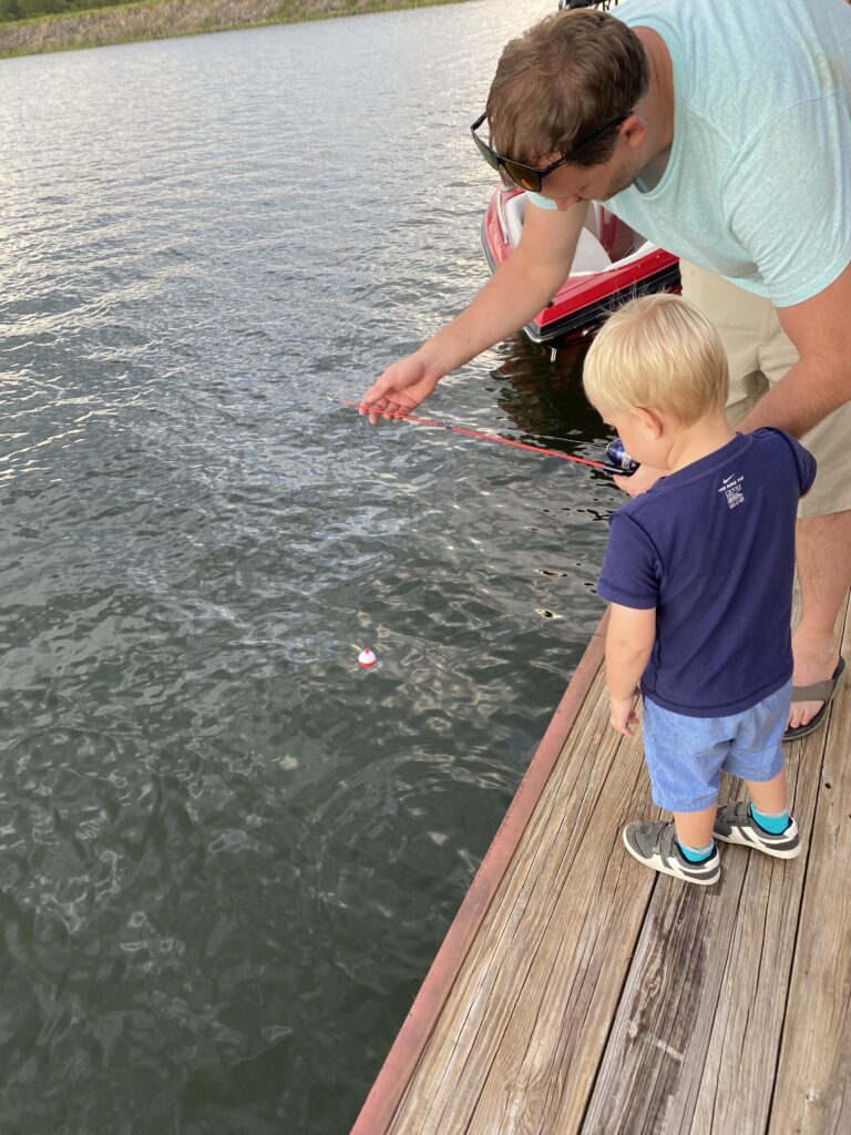 Dad and Son on a dock at the lake fishing