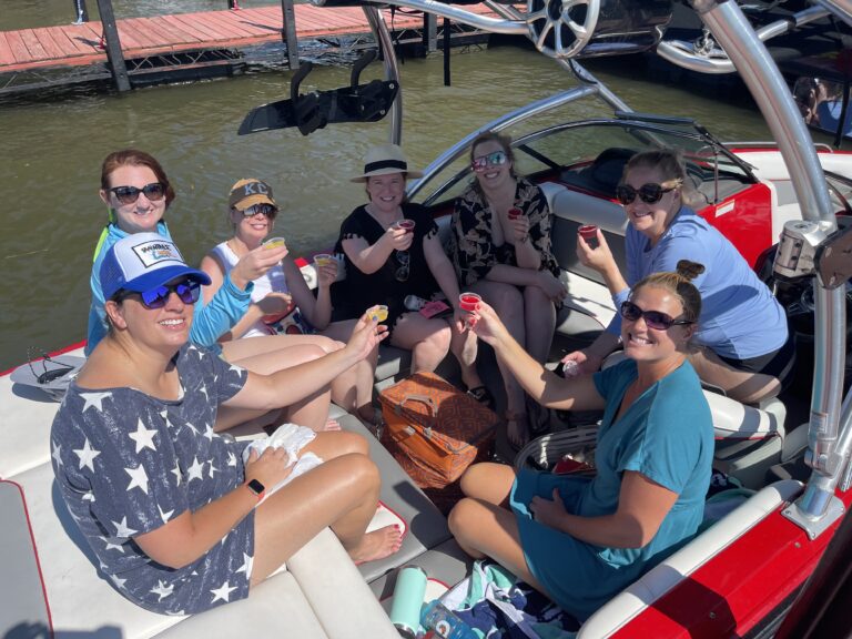 Group of girls on a boat taking shots