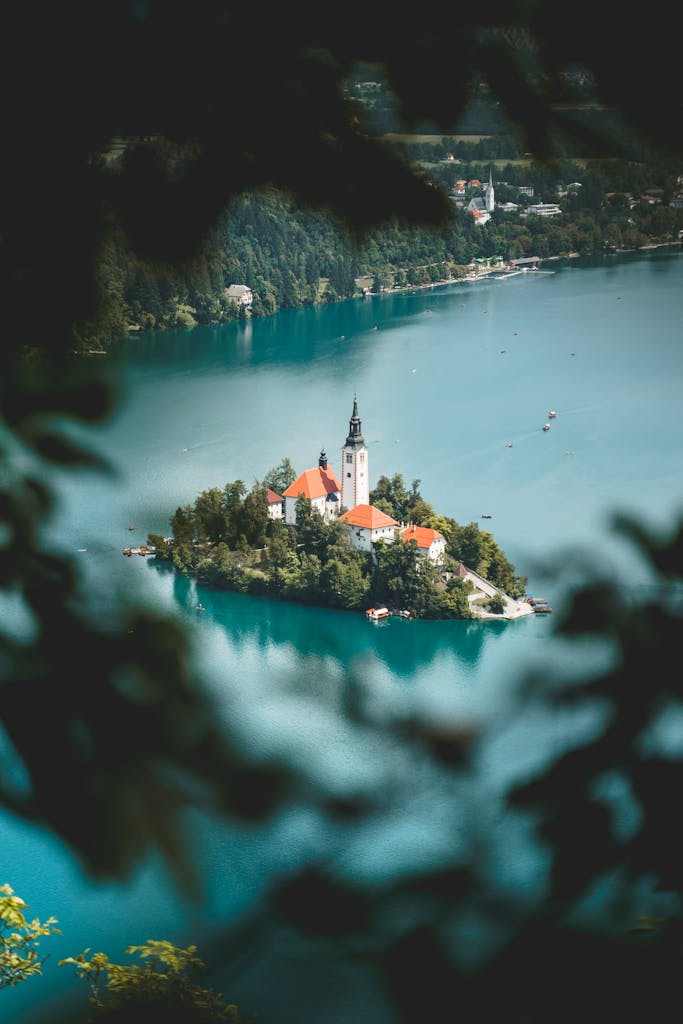 A breathtaking view of the Church of the Assumption on Lake Bled, Slovenia, surrounded by turquoise waters.