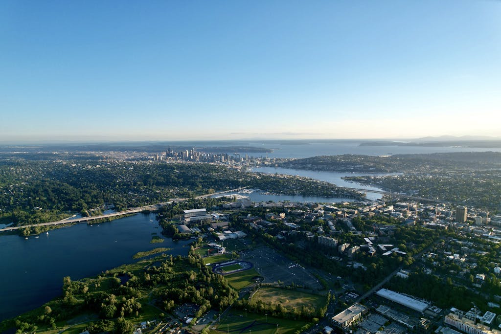 Stunning aerial view of Seattle's skyline and Lake Washington under a clear blue sky.