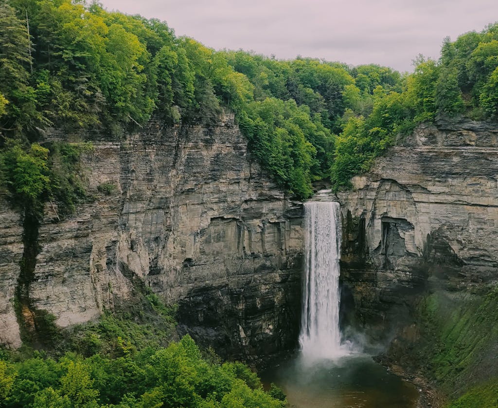 Stunning view of Taughannock Falls surrounded by lush greenery in Trumansburg, NY.