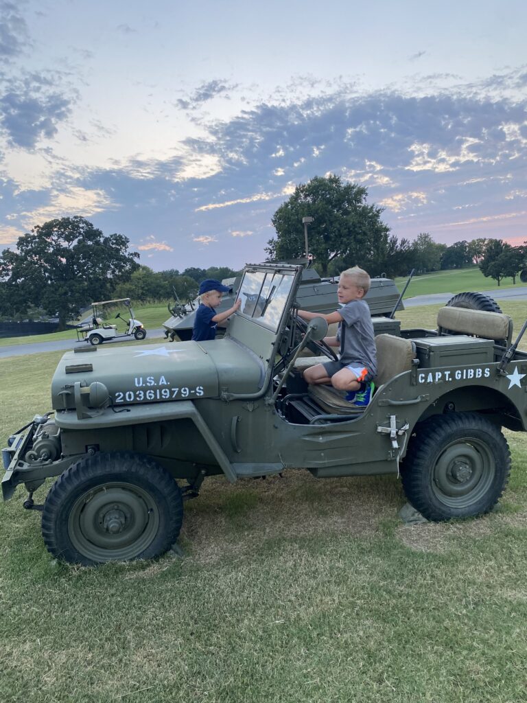 Kids driving an army jeep parked on a golf course at Grand Lake, OK