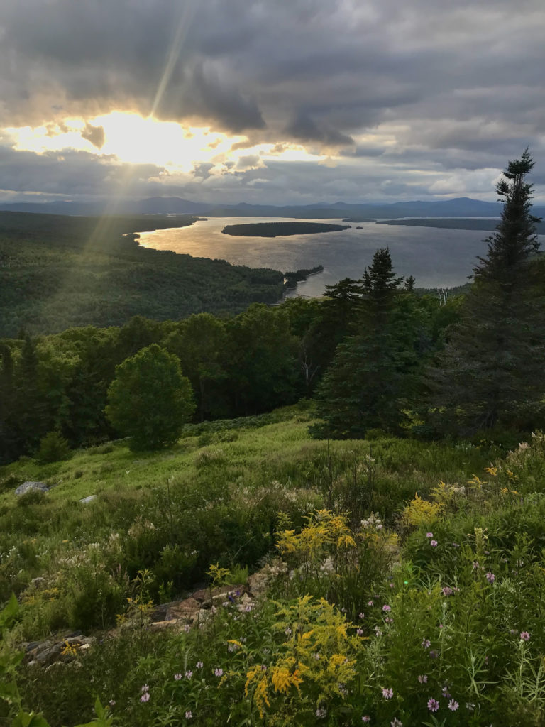 Aerial view of Rangeley Lake, ME with sun setting