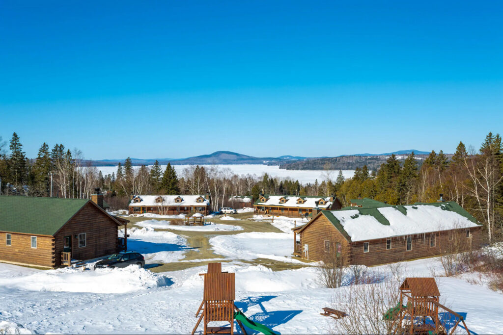 Rangeley Lake, ME in the winter with a dusting of snow covering some cabins