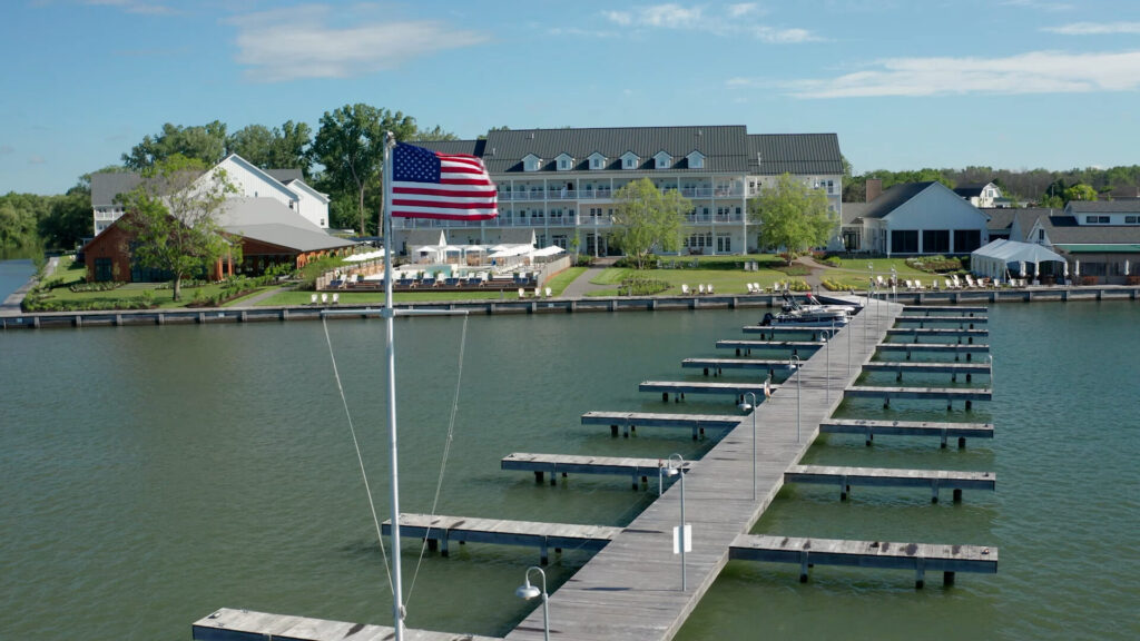 View of the docks and an American Flag outside of the front of the Lake House on Canandaigua, NY