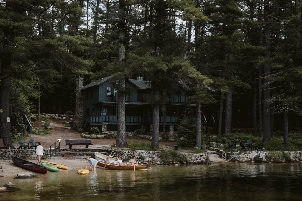 Migis Lodge shoreline with kayakers in front of one of the cabins