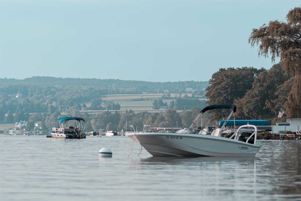 Peaceful scene of boats on a Lake in, New York, with a serene landscape backdrop.