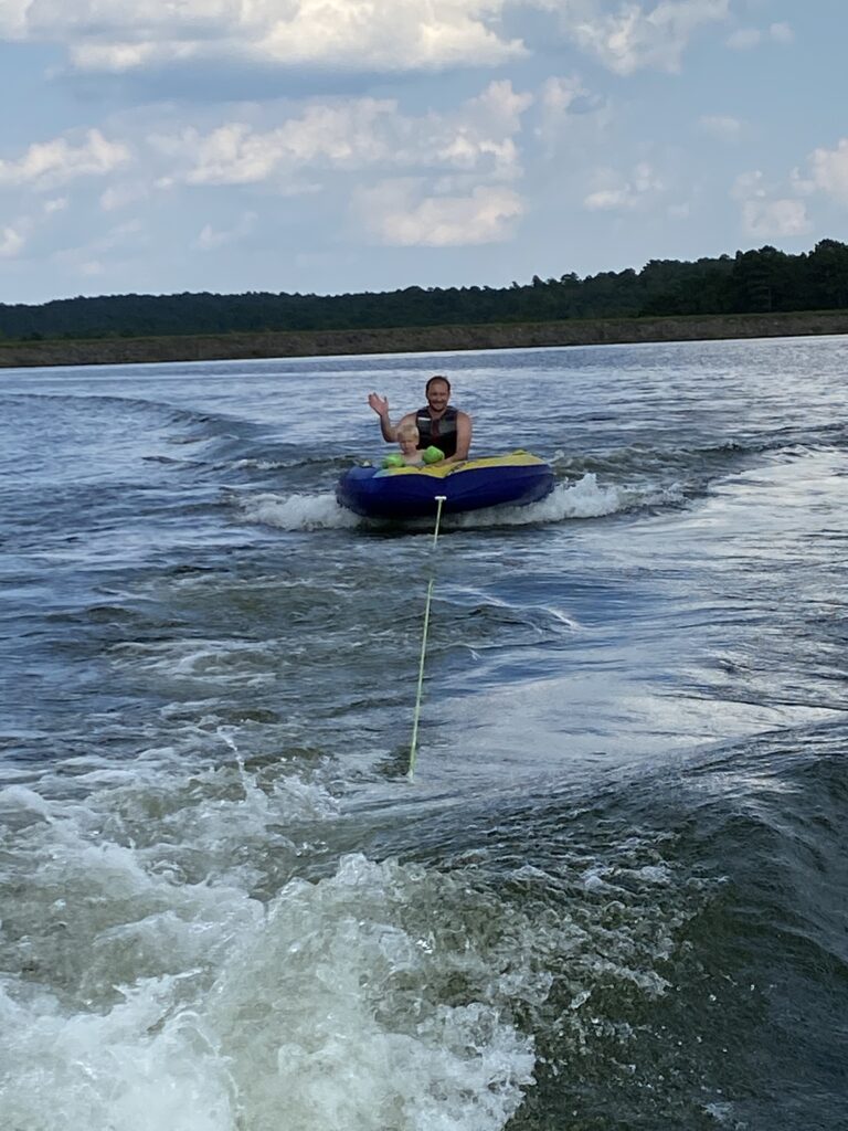 Tubing on a lake behind a boat