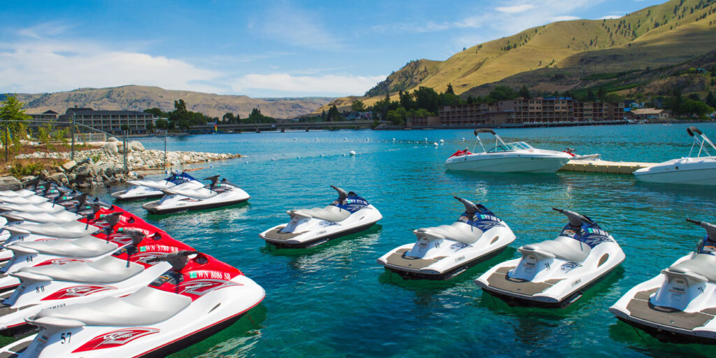 Boats and Jet Skis parked on Lake Chelan for renting